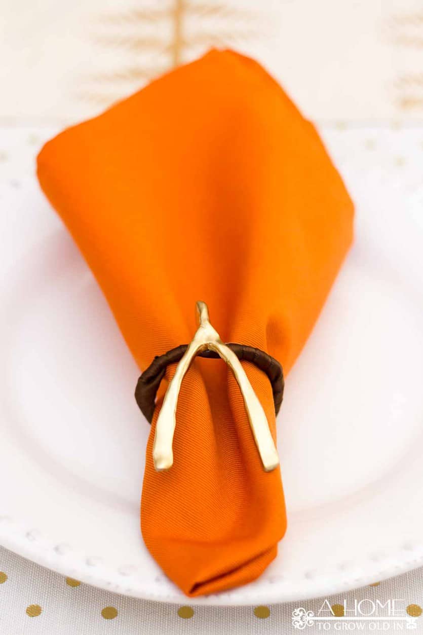 These DIY wishbone napkin rings are so simple and make such cute decorations! They will look fantastic with your Thanksgiving table settings! #thanksgiving #thanksgivingtable #fall thanksgivingtablescape #thanksgivingdecor #tablesetting #falldecorations