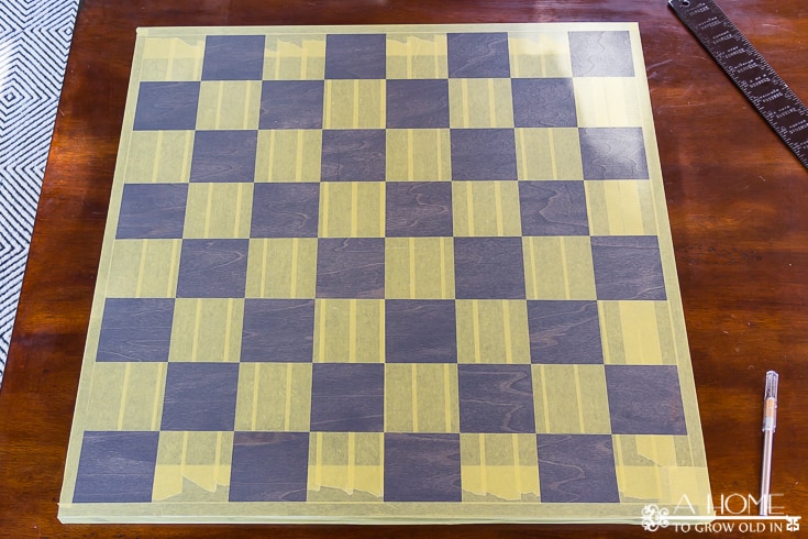 stained wood that is taped off for checkers