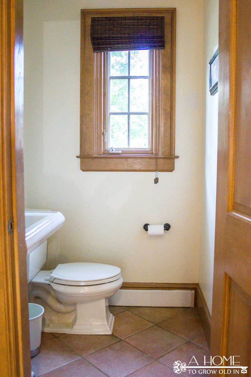 This transitional farmhouse powder room makeover is full of amazing DIYs like faux cement tiles and wooden planked walls! Great ideas for projects you can do yourself. You won't believe the transformation!