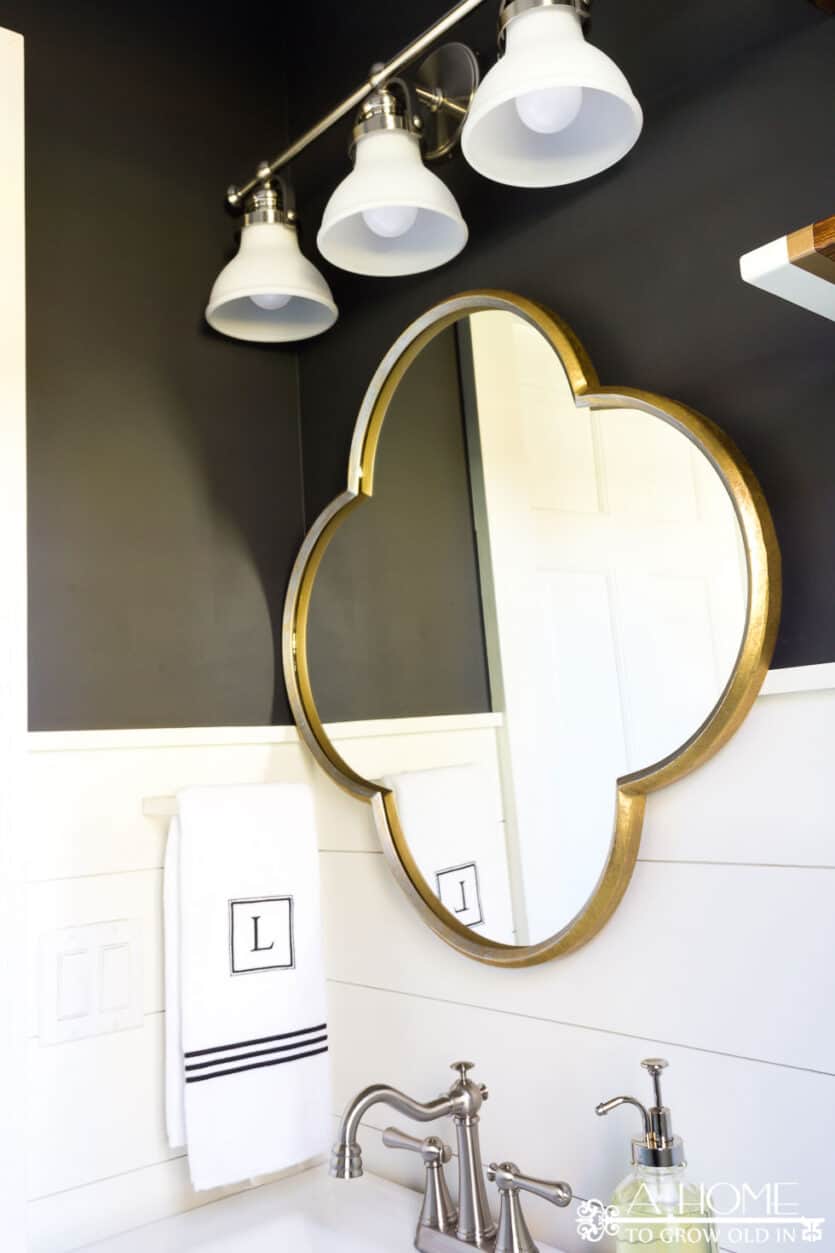 This transitional farmhouse powder room makeover is full of amazing DIYs like faux cement tiles and wooden planked walls! Great ideas for projects you can do yourself. You won't believe the transformation!
