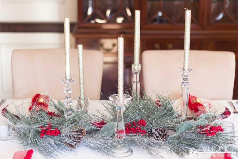 This simple and elegant Christmas tablescape has lots of fun elements like DIY plaid placemats, fringed napkins, and a snowy centerpiece.