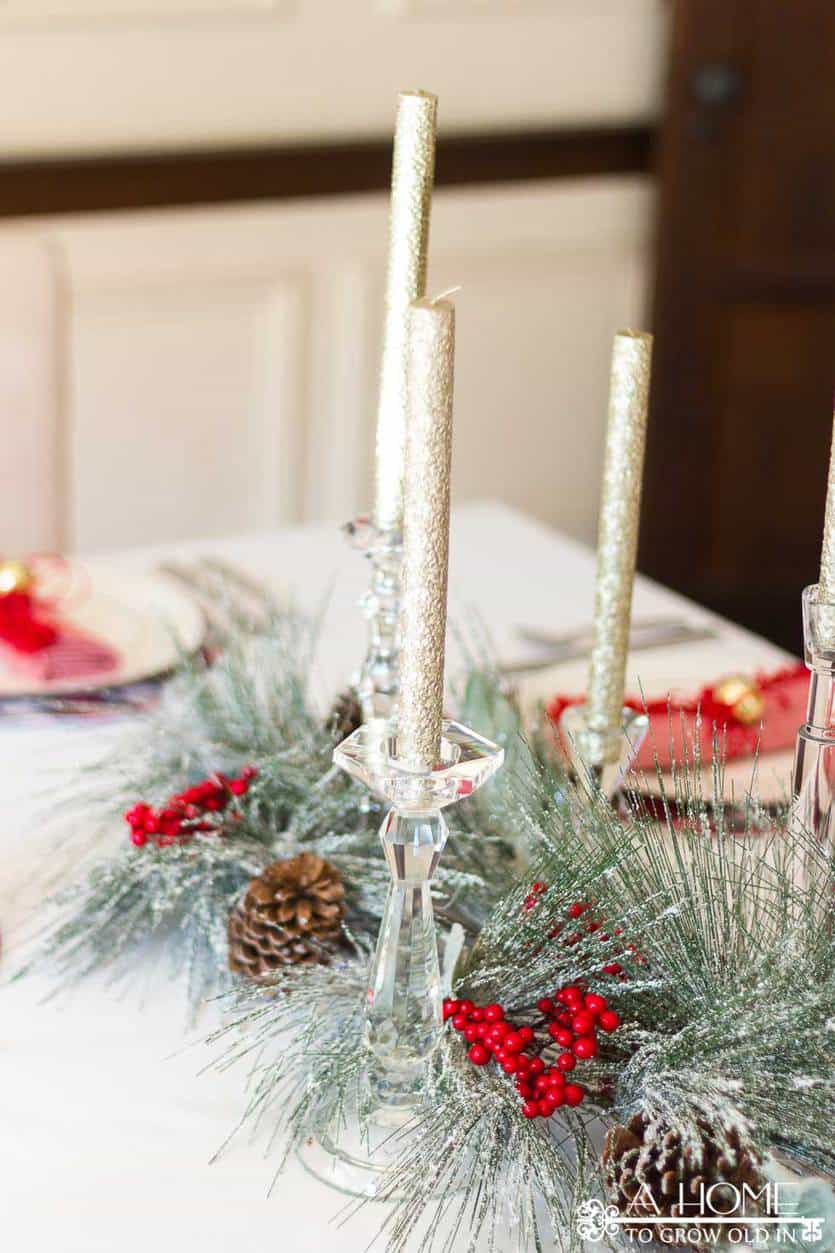 This simple and elegant Christmas tablescape has lots of fun ideas like DIY red and white plaid placemats, fringed napkins, and a beautiful snowy centerpiece. #christmastablescape #christmas