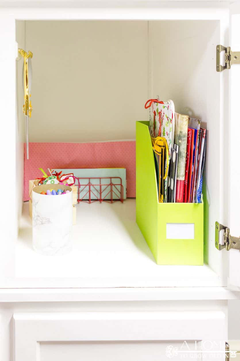 It's easy to repurpose an old armoire into a beautiful and organized gift wrapping station for your craft room! Lots of ideas on how to DIY this yourself!