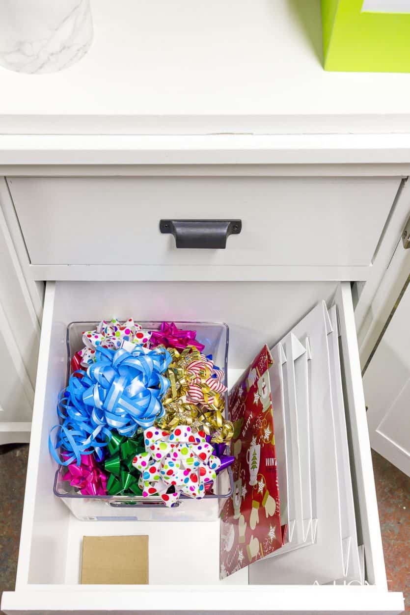 It's easy to repurpose an old armoire into a beautiful and organized gift wrapping station for your craft room! Lots of ideas on how to DIY this yourself!