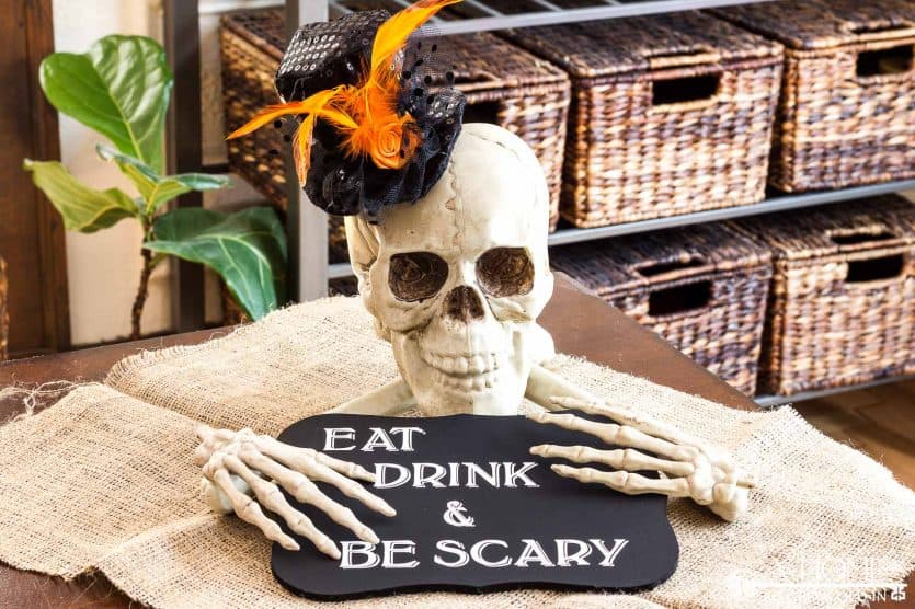 DIY halloween skull and bones centerpiece with eat drink and be scary sign