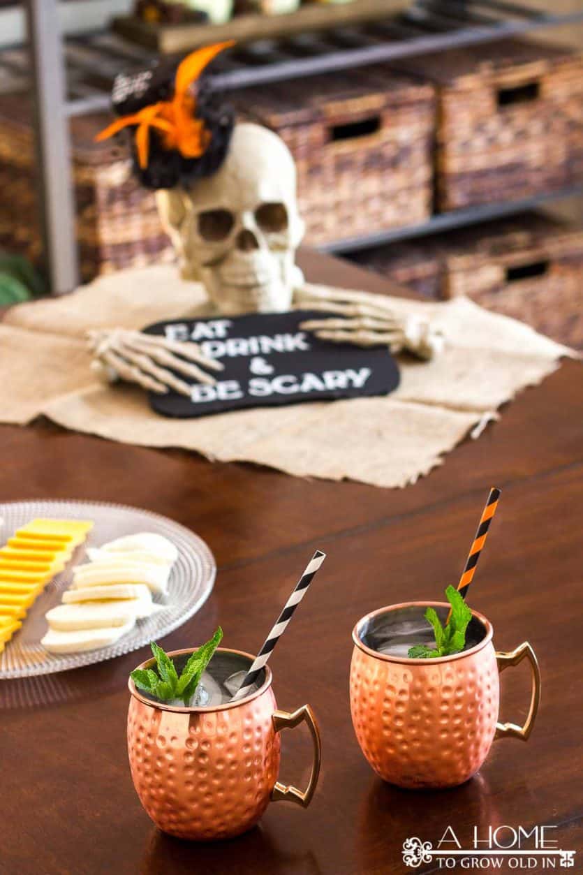 DIY halloween skull and bones centerpiece with eat drink and be scary sign