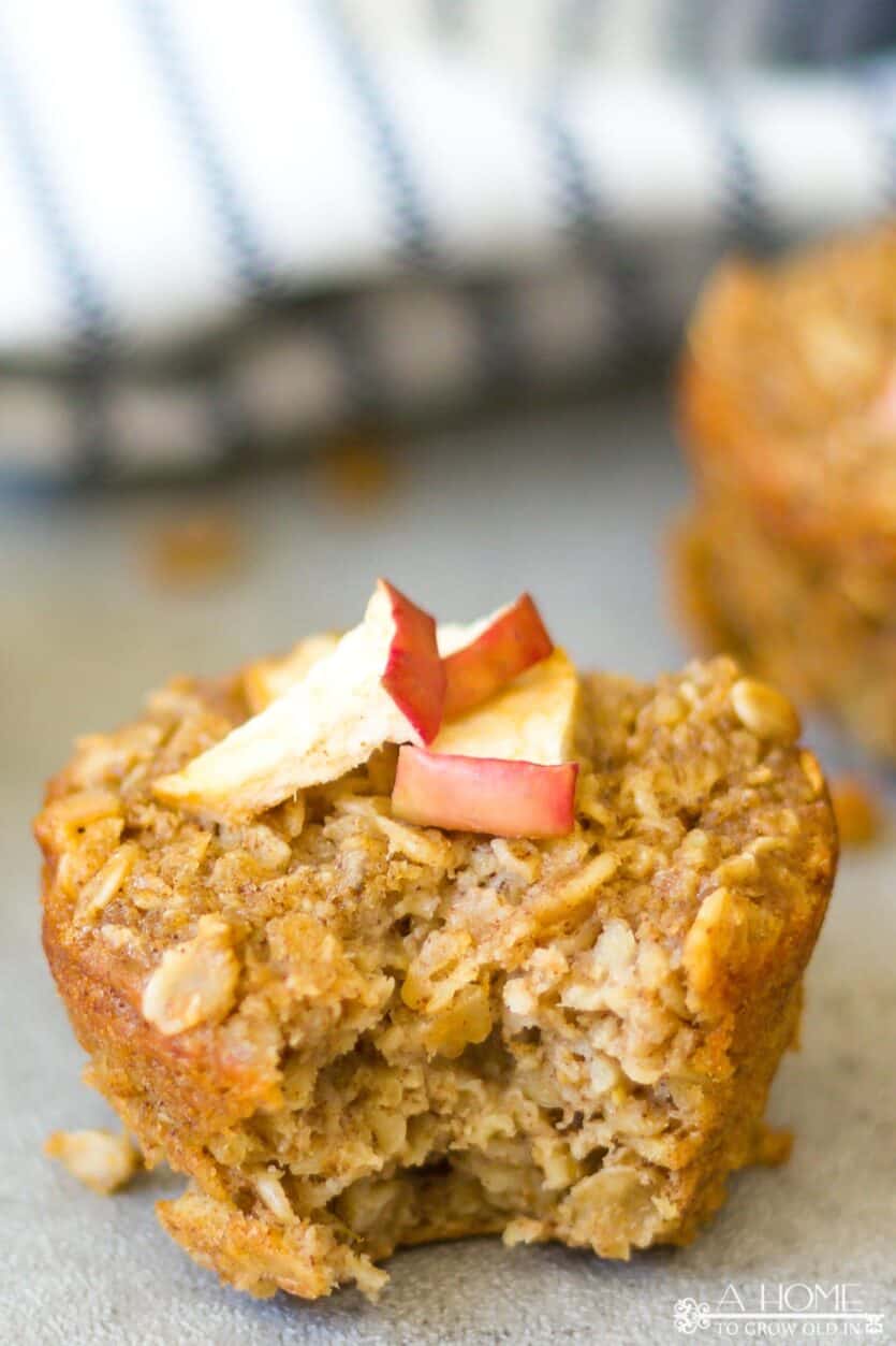 A cinnamon apple oatmeal muffin with a bite taken out of it