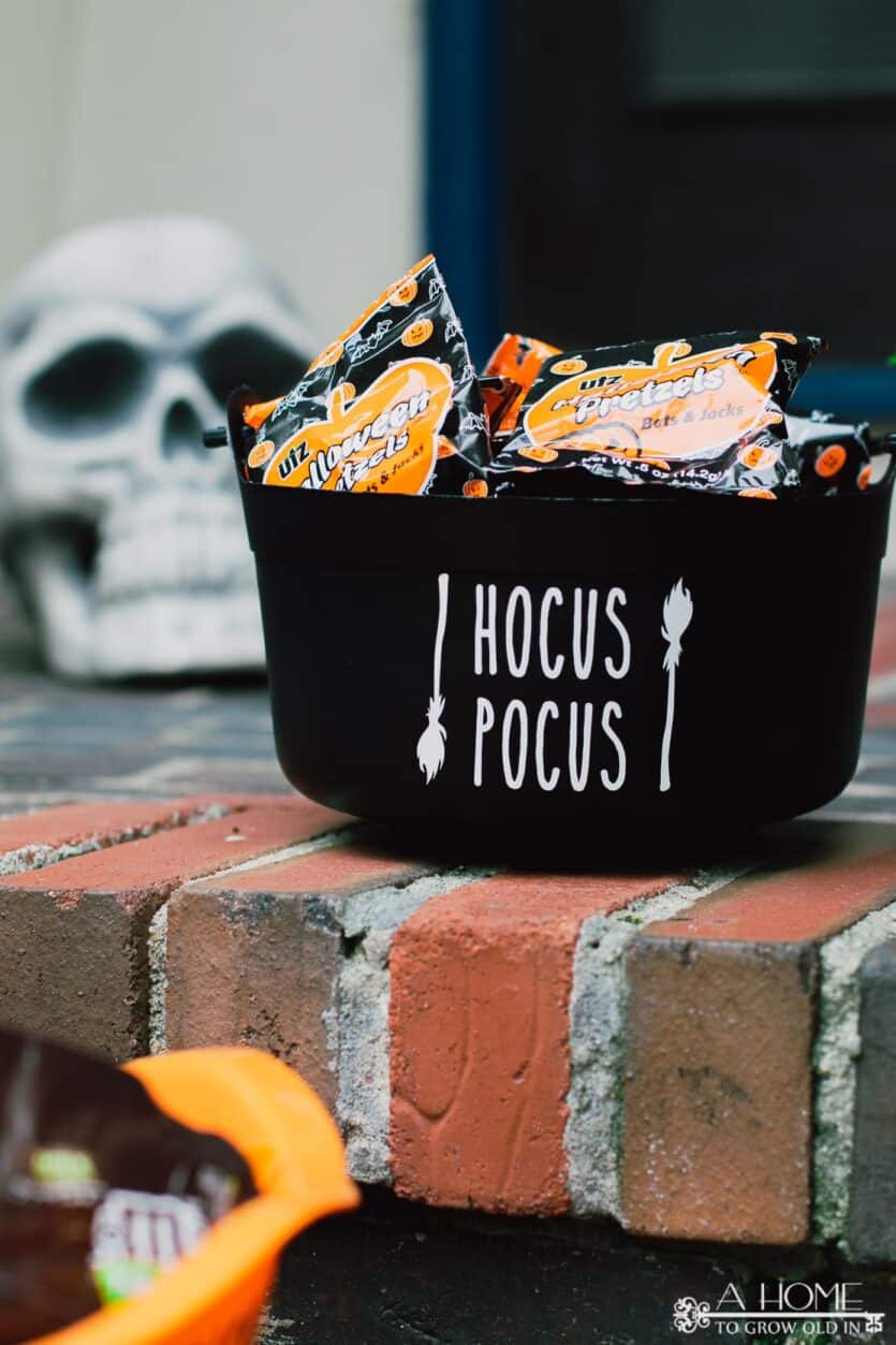 black cauldron Halloween candy bowl filled with pretzels