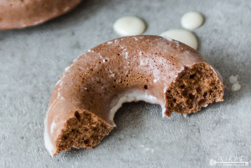 baked chocolate glazed donut with bite taken out of it