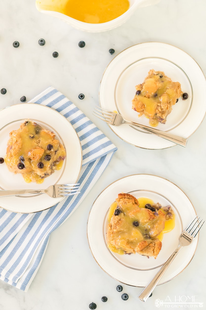 lemon blueberry bread pudding with a lemon curd sauce served on dishes