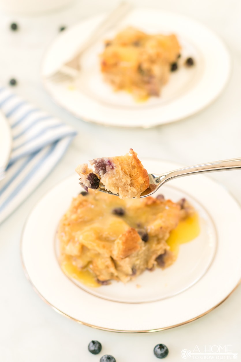 a bite of lemon blueberry bread pudding on a fork